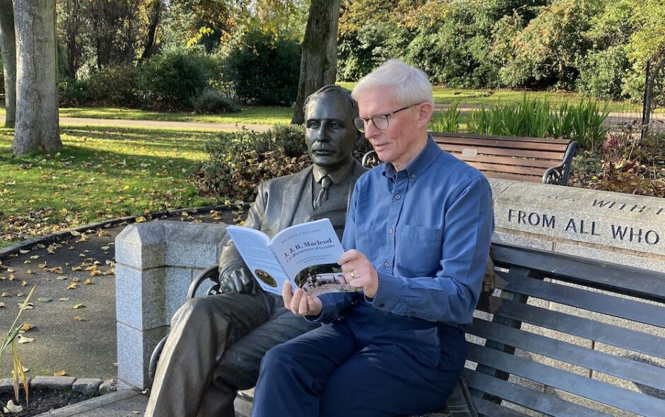 Dr Kenneth McHardy at JJR Macleod Memorial Statue with newly published biography of Macleod