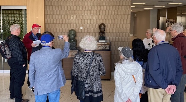 Christopher Rutty guiding walking tour, busts of Banting and Best
